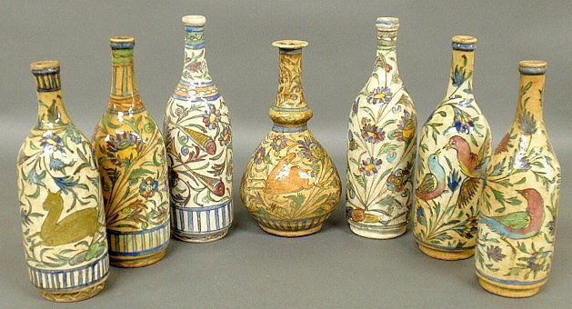 Seven colorful Persian earthenware bottles, 18th/19th: Seven colorful Persian earthenware bottles, 18th/19th c., some with floral decoration, some with floral and animal decoration. Tallest 13.5"h.