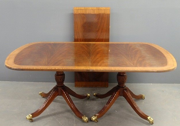 Duncan Phyfe style inlaid mahogany dining table with br: Duncan Phyfe style inlaid mahogany dining table with brass paw feet and two leaves. 28.5”h.x46”w.x113”l. fully extended.Note: lot is photographed showing one of two leaves that are 20"l. each