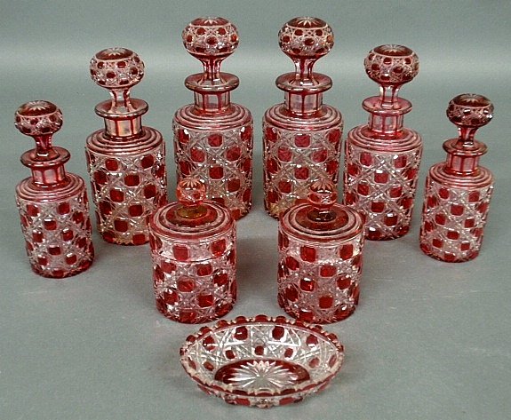Cranberry-cut-to-clear Bohemia glass toiletry set, 19th: Cranberry-cut-to-clear Bohemia glass toiletry set, 19th c., nine pieces, tallest 8.5"h.