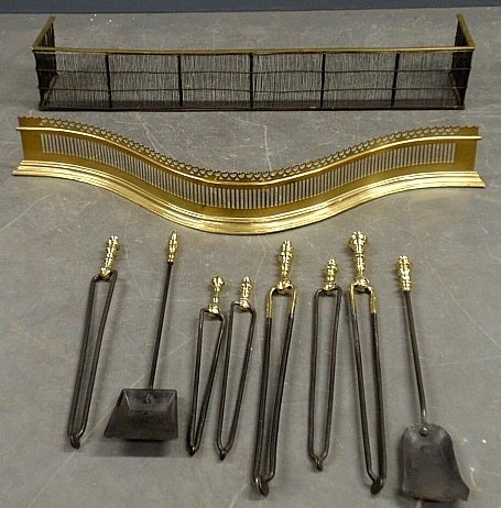 Six 18th c. brass and iron fireplace tongs longest 30": Six 18th c. brass and iron fireplace tongs longest 30" & two shovels, a brass and wire fire fender 47.5"l.x5"d. and a brass serpentine reproduction example marked "Williamsburg" 48"l.x12"d.