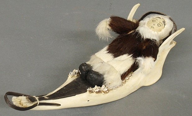 Inuit jawbone and baleen sled with Eskimo child doll.: Inuit jawbone and baleen sled with Eskimo child doll. 4.5"h.x13"l.x4.5"w.