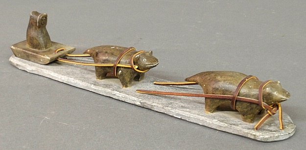 Inuit stone carving of a sled with dogs, signed "Eimu".: Inuit stone carving of a sled with dogs, signed "Eimu". 3"h.x15"l.x3.5"w.