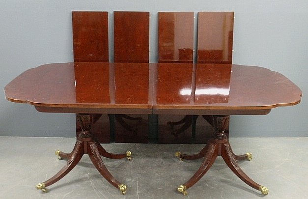 Duncan Phyfe style mahogany dining table with pedestal: Duncan Phyfe style mahogany dining table with pedestal base and four extra leaves 12" each. 29.5"h.x47"w.x126"l. fully extended