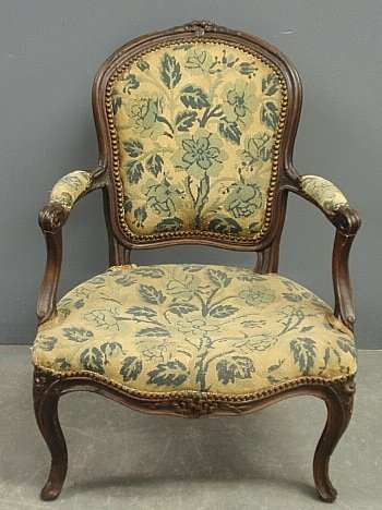 French walnut fauteuil, 18th c., with old needlepoint: French walnut fauteuil, 18th c., with old needlepoint upholstery. 34"h.x24"w.x20"d., seat 14"h.