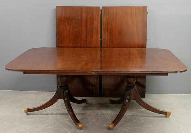 Duncan Phyfe style mahogany banquet table by Saybolt: Duncan Phyfe style mahogany banquet table by Saybolt Cleland, Philadelphia, with a double pedestal base and two extra leaves 24" each. 29"h.x50"w.x121"l. fully extended