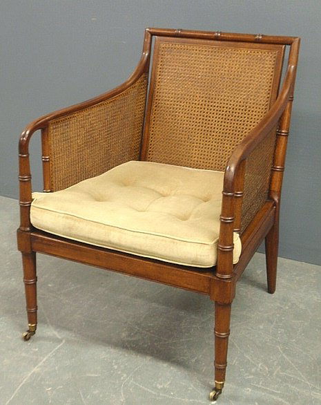 Mahogany armchair by Kittinger with caned back and: Mahogany armchair by Kittinger with caned back and sides and front casters. 34"h.x24"w.x24"d., seat 18"h.