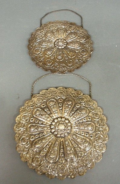 Two repoussÃ© silver round hanging mirrors, each marked: Two repoussÃ© silver round hanging mirrors, each marked "Bedo" (Turkish) and "900". 9"dia. & 10.5" dia.
