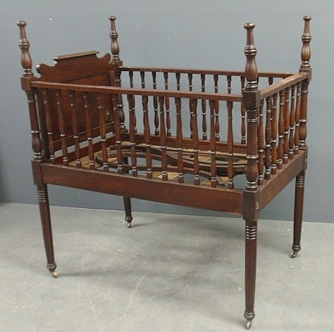 Sheraton mahogany crib. C.1820, with fold-down side and: Sheraton mahogany crib. C.1820, with fold-down side and tester braces. 51"h.x46"l.x30"w.
