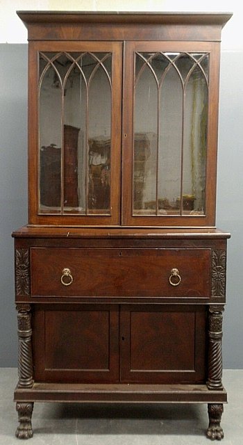 Classical Empire mahogany two-part butler's secretary: Classical Empire mahogany two-part butler's secretary desk, c.1840, with gothic mullioned glass doors, pull-out writing surface above two doors all flanked by freestanding carved columns and resting o