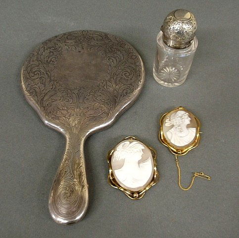Sterling silver hand mirror 9.25”l., a small bottle wit: Sterling silver hand mirror 9.25”l., a small bottle with silver lid and two carved cameo brooches, largest 2.5”x1.75”