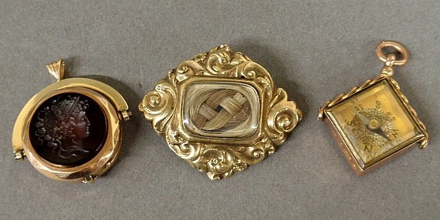 Two Victorian watch fobs- 14k gold w/Roman head carved: Two Victorian watch fobs- 14k gold w/Roman head carved carnelian & black onyx 1.25”, a 9k gold compass & bloodstone example tog. with a Victorian gold/silver mourning pin with braided hair.