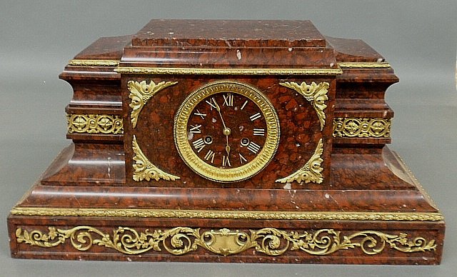 Large French red marble mantel clock, late 19th c.,: Large French red marble mantel clock, late 19th c., with fire gilt ormolu mounts and Roman numerals. Lacking pendulum. 11.25"h.x22.25"w.x10"d.