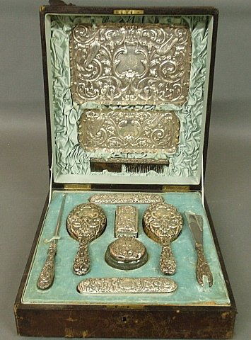 Large ornate English silver dresser set in a: Large ornate English silver dresser set in a monogrammed leather presentation case with satin lining. Case- 5"h.x14.5"w.x16"d.