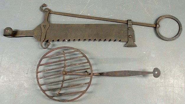 Large wrought iron 18th c. saw tooth trammel with: Large wrought iron 18th c. saw tooth trammel with cut-out heart decoration 49"l., and a wrought iron trivet 29"l.x13.5"dia.