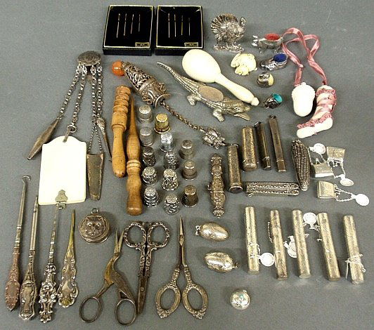 Group of silver sewing and needlework items, small: Group of silver sewing and needlework items, small silver accessories, gold-plated needles, wooden sewing items, etc., many marked "Sterling", TI needle cases, chatelaines, scissors., etc.
