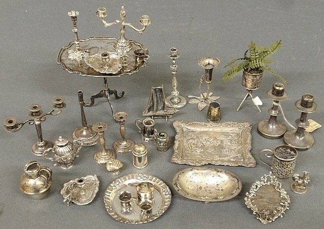 Group of miniature silver and silverplate furniture and: Group of miniature silver and silverplate furniture and accessories incl. a tea table (unmarked) 3"h.x4.125", chamber sticks marked "830", candelabra, serving trays, etc.
