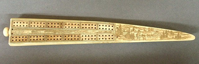 Walrus scrimshaw cribbage board, 19th c., with dog sled: Walrus scrimshaw cribbage board, 19th c., with dog sled and figures in a wooded landscape. 10.75"l.x1.5"w.