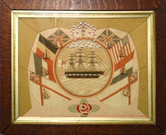 Fine framed English sailor's woolie of an English: Fine framed English sailor's woolie of an English frigate surrounded by various flags and tassels and a crown done in stitched on lavender seashells above the ship. Site- 12.5"x16.25"