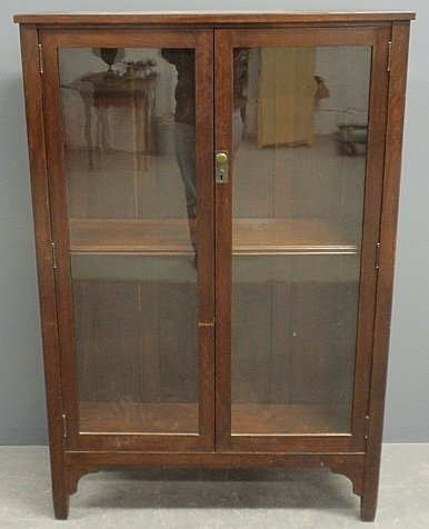 Stickley Brothers "Quaint Furniture" oak bookcase with: Stickley Brothers "Quaint Furniture" oak bookcase with glass doors and original label. 55.5"h.x37.5"w.x12.75"d.