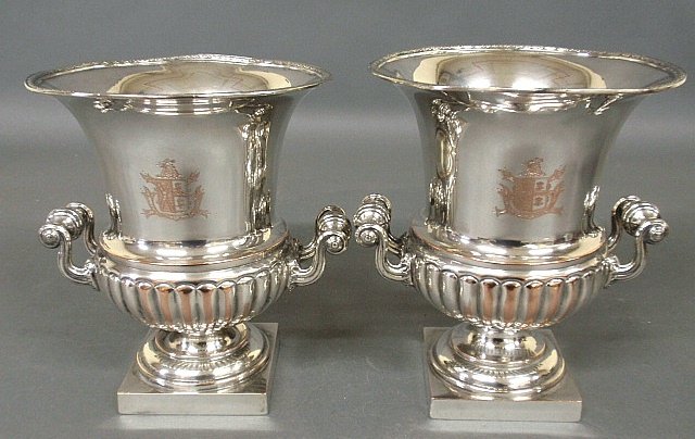Pair of silverplate wine coolers with armorial crests: Pair of silverplate wine coolers with armorial crests and square plinth bases. 9.75"h.x8"dia.