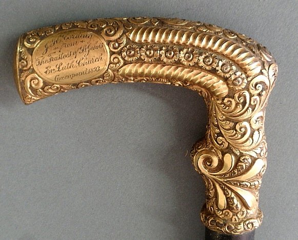 Ebony presentation walking stick with a gold-filled: Ebony presentation walking stick with a gold-filled handle inscribed "J.H. Cording From the Trustees of St. John's Ev. Luth. Church, Greenpoint 1893". 35.5"l.