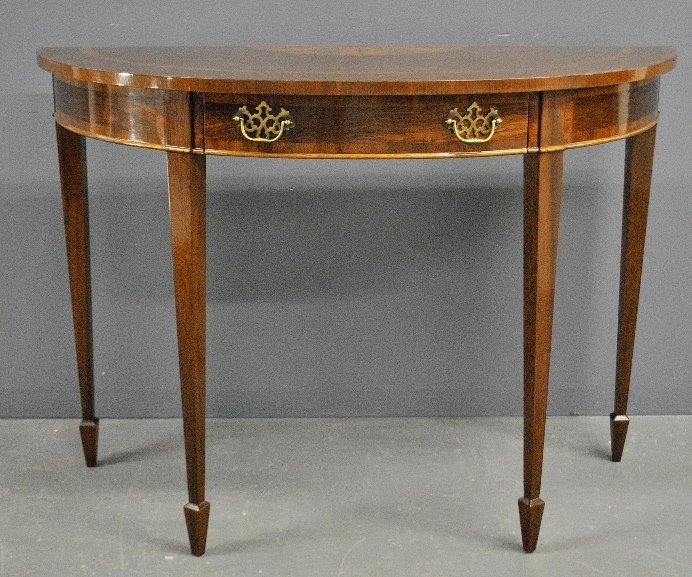 Hepplewhite style mahogany demilune table by Council: Hepplewhite style mahogany demilune table by Council with single drawer. 32.5"h.x45.5"w.x19"d.