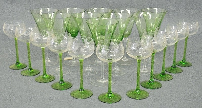 Ten Steuben green glass goblets with clear stems 8"h.,: Ten Steuben green glass goblets with clear stems 8"h., and eleven wines with green stems and grapevine decoration to the bowls 7"h., (maker unknown)
