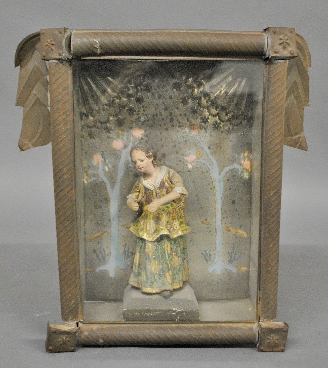 Carving of a Mexican woman mounted in a tin shadow box,: Carving of a Mexican woman mounted in a tin shadow box, 20th c. 12.5"h.x11"w.x4"d.