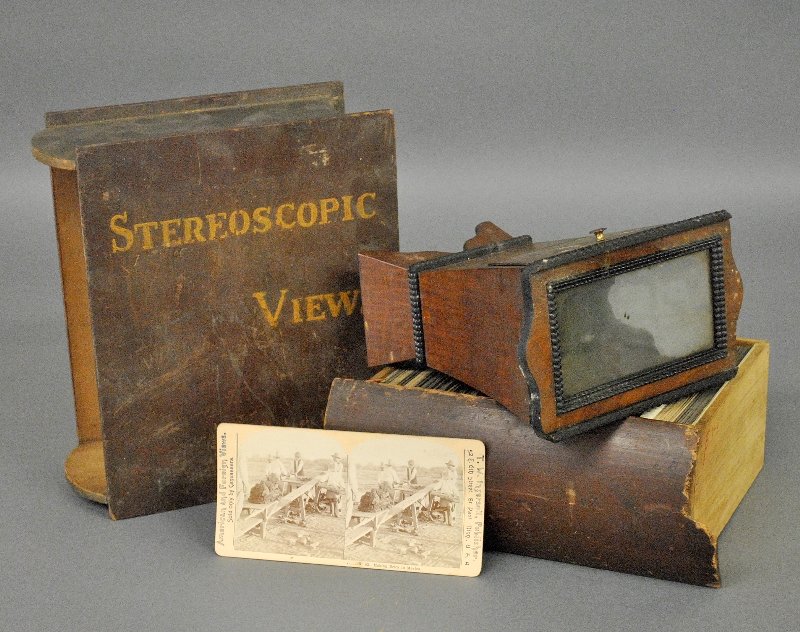 Stereoscopic viewer cards of America, some in color,: Stereoscopic viewer cards of America, some in color, over 100 cards in a wood book-form case and a stereo viewer.