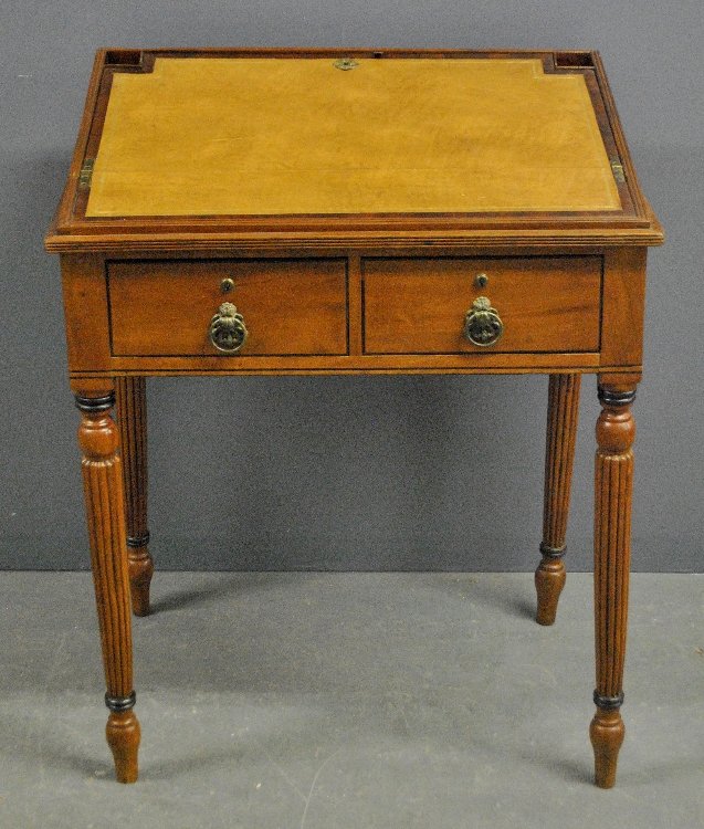 Sheraton Regency mahogany slant-lid desk with leather: Sheraton Regency mahogany slant-lid desk with leather top, two drawers and turned reeded legs. 36"h.x28"w.x21"d.