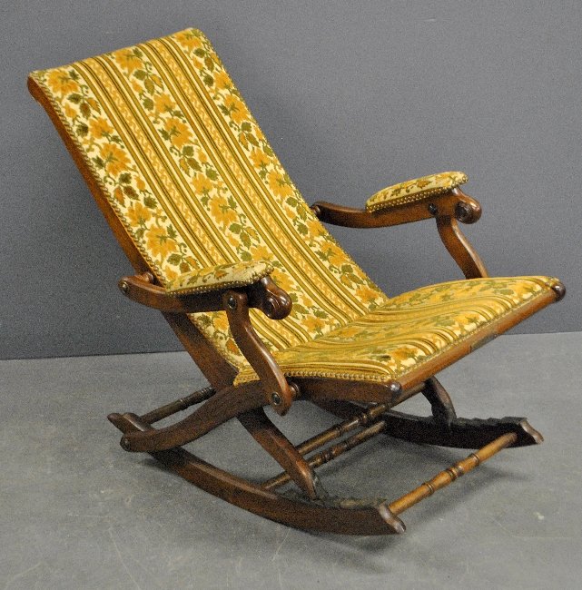 Hunzinger adjustable carved walnut rocker labeled: Hunzinger adjustable carved walnut rocker labeled :Hunzinger Patd. Feb. 18th, 1873". Approx. 36"h.x25"w.