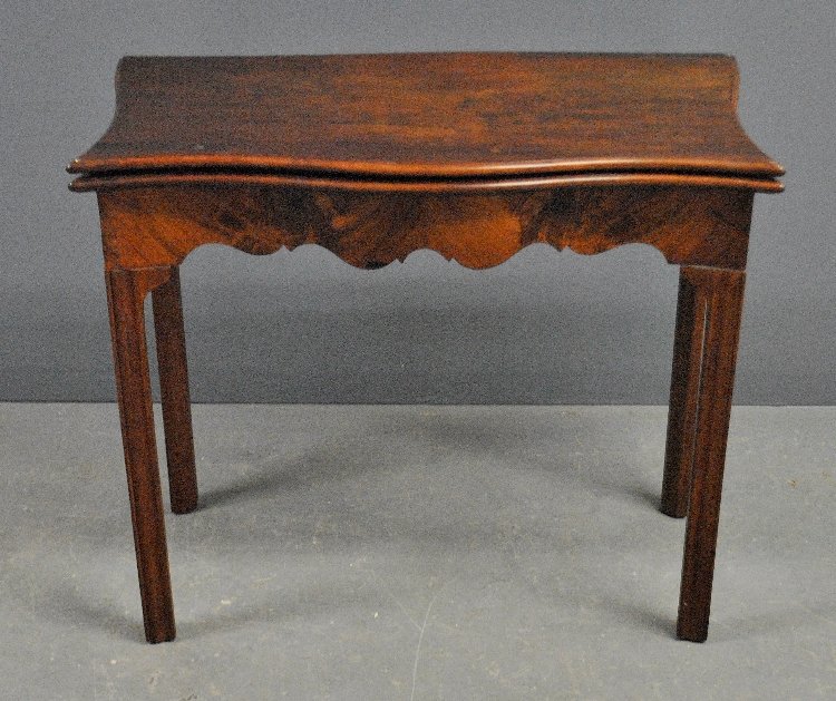 Georgian mahogany card table with a flip top, secret: Georgian mahogany card table with a flip top, secret drawer, scalloped apron and square molded legs. 29"h.x33.5"w.x16.5"d.