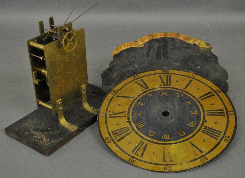 Brass clock works with a Fusee movement, 5 "h., the: Brass clock works with a Fusee movement, 5 "h., the saddle board 12.5"w.x 6.25"d, together with a German painted clock dial, 21.5"h
