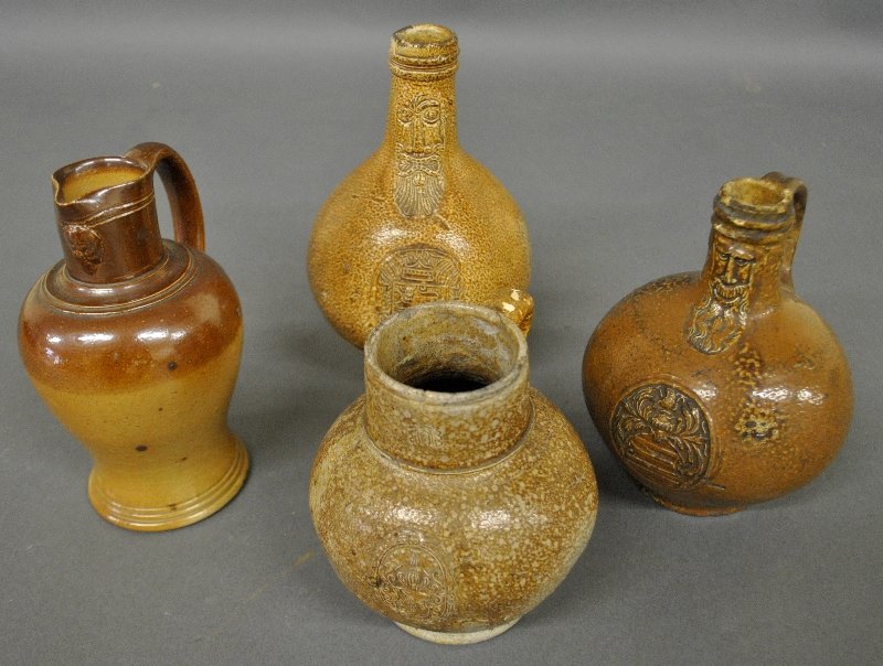 Three Bellarmine pottery jugs each with incised crests, (1 of 4)