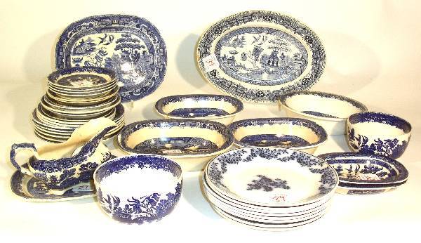 Assembled group of Blue Willow china: Blue Willow china to include saucers, bowls, deep bowls, platters, sauce dishes and French Flow Blue plates. Chips, cracks.