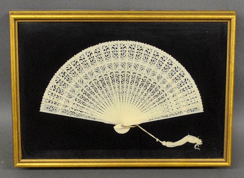 Bone Victorian fan mounted in a shadow box frame. Fan: Bone Victorian fan mounted in a shadow box frame. Fan 7"h.x12"w. Frame overall 11"h.x16"w.