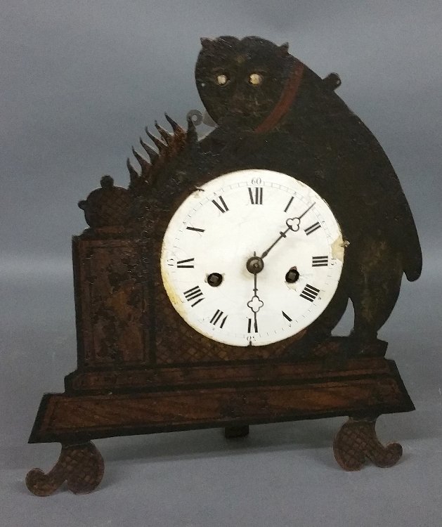 French metal mantle clock in the form of a cat with: French metal mantle clock in the form of a cat with moving eyes, 19th century. 13.5" h x 12" w