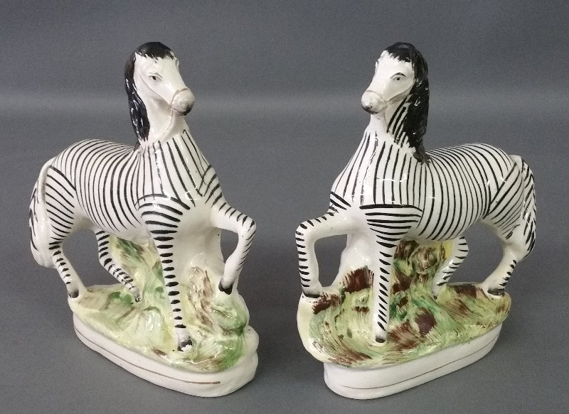 Pair of Staffordshire prancing zebras, c. 1870. 9: Pair of Staffordshire prancing zebras, c. 1870. 9 inches high, 8 inches wide.