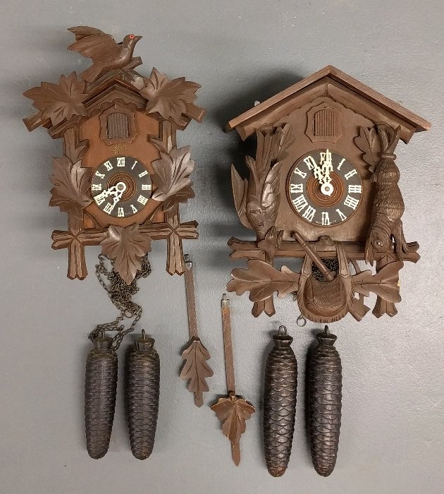 German cuckoo clock by Jahresuhrenfabrik, 13 inches: German cuckoo clock by Jahresuhrenfabrik, 13 inches high x 10 inches wide, together with another by Schatz.