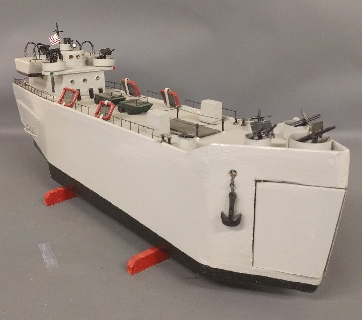 Wood ship model of a LST (Landing Ship, Tank) by: Wood ship model of a LST (Landing Ship, Tank) by Mansell, 1993. 15 inches high, 38 inches long, 9 inches wide.