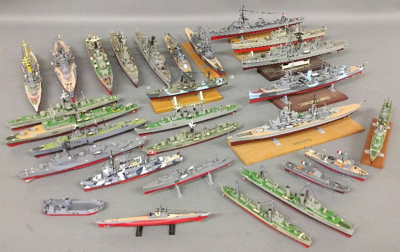 Misc. grouping of approx. twenty-eight ship models of: Misc. grouping of approx. twenty-eight ship models of various sizes to include the HMS Belfast, HMS Cossack and HMS Cadiz. As found. Largest: 13 inches long.