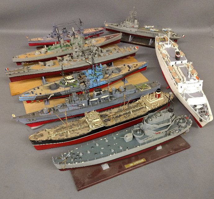 Collection of nine ship models to include the USS Carro: Collection of nine ship models to include the USS Carronade, HMS Howe and Jeanne d’Arc. As found.Longest: 25 ½ inches long.