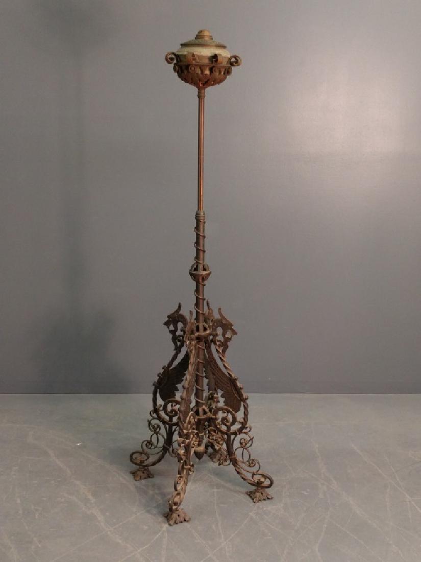 Bradley and Hubbard wrought iron: Bradley and Hubbard wrought iron piano lamp, circa 1880, converted to electricity, with the base in the form of dragons. 62"h. x 23"w.