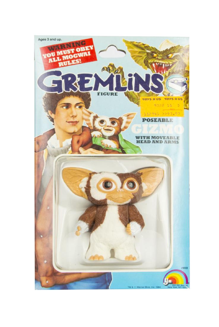"Gremlins" Poseable Gizmo.: (Warner Bros, 1984) A rare poseable Gizmo toy based on the character from the feature film "Gremlins". Created by LJN, this toy is unopened in its original box with its original Toys 'r' Us sales stic