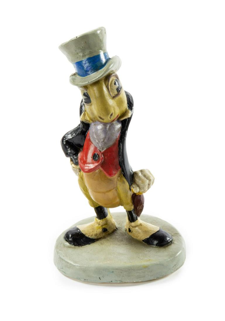Jiminy Cricket Animator's Maquette from Pinocchio.: (Walt Disney Studios, c.1939) A very rare production maquette used during the creation of the feature film Pinocchio. The hand-painted plaster sculpture features an early version of Jiminy Cricket. Ma