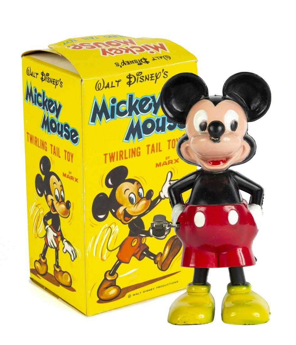 Mickey Mouse Twirling Tail Toy by Marx.: (Marx, c.1950s) A hard plastic Mickey Mouse Twirling Tail Toy in its original box. This wonderful depiction of Mickey has a turnkey in the side that when wound, causes Mickey's tail to spin around qui