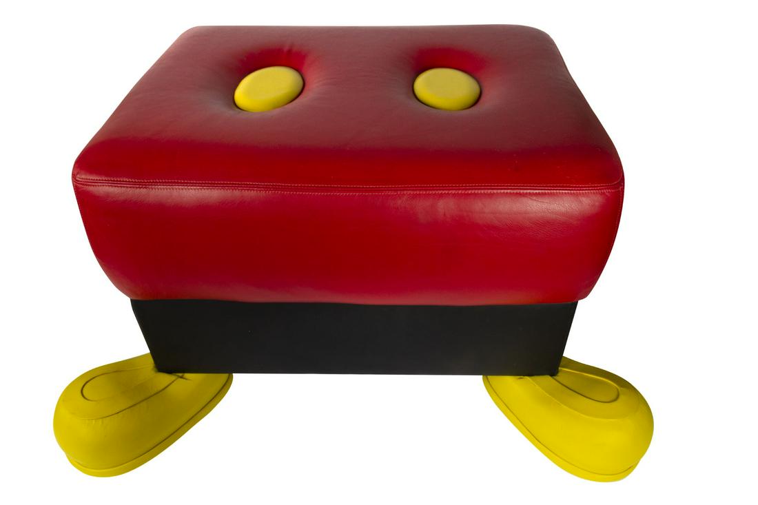 Mickey Mouse Ottoman.: (Walt Disney Studios, c.1990s) A rare Mickey Mouse ottoman created by designer Paddy Gordon. This ottoman features Mickey's trademark buttons on the top, with his large yellow shoes serving as the fee