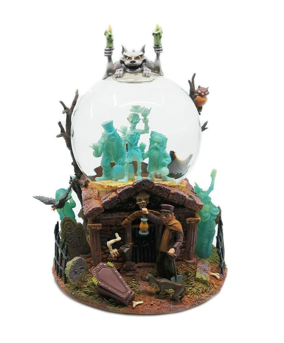 Haunted Mansion Musical Snow Globe.: (Disneyland, c.1990s) A charming snow globe featuring iconic characters from the Haunted Mansion attraction at Disneyland. The Hitchhiking Ghosts are inside the globe, while the Caretaker and other fa