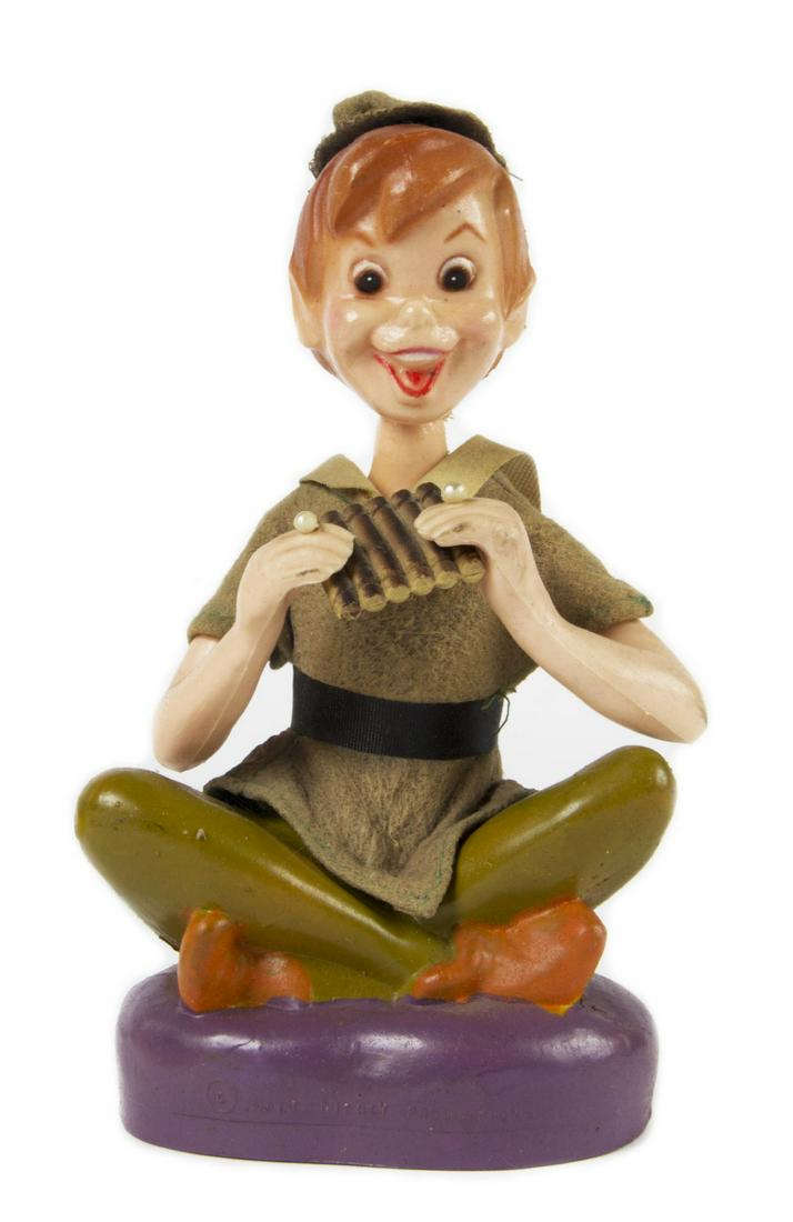 Peter Pan Hand-Painted Vinyl Figure in Box.: (Walt Disney Studios, c.1960s) A hand-painted Peter Pan figure from the Golden Fantasy line of Small World Figures. Created in vinyl with a fabric tunic and hat, this rare figure comes in its original