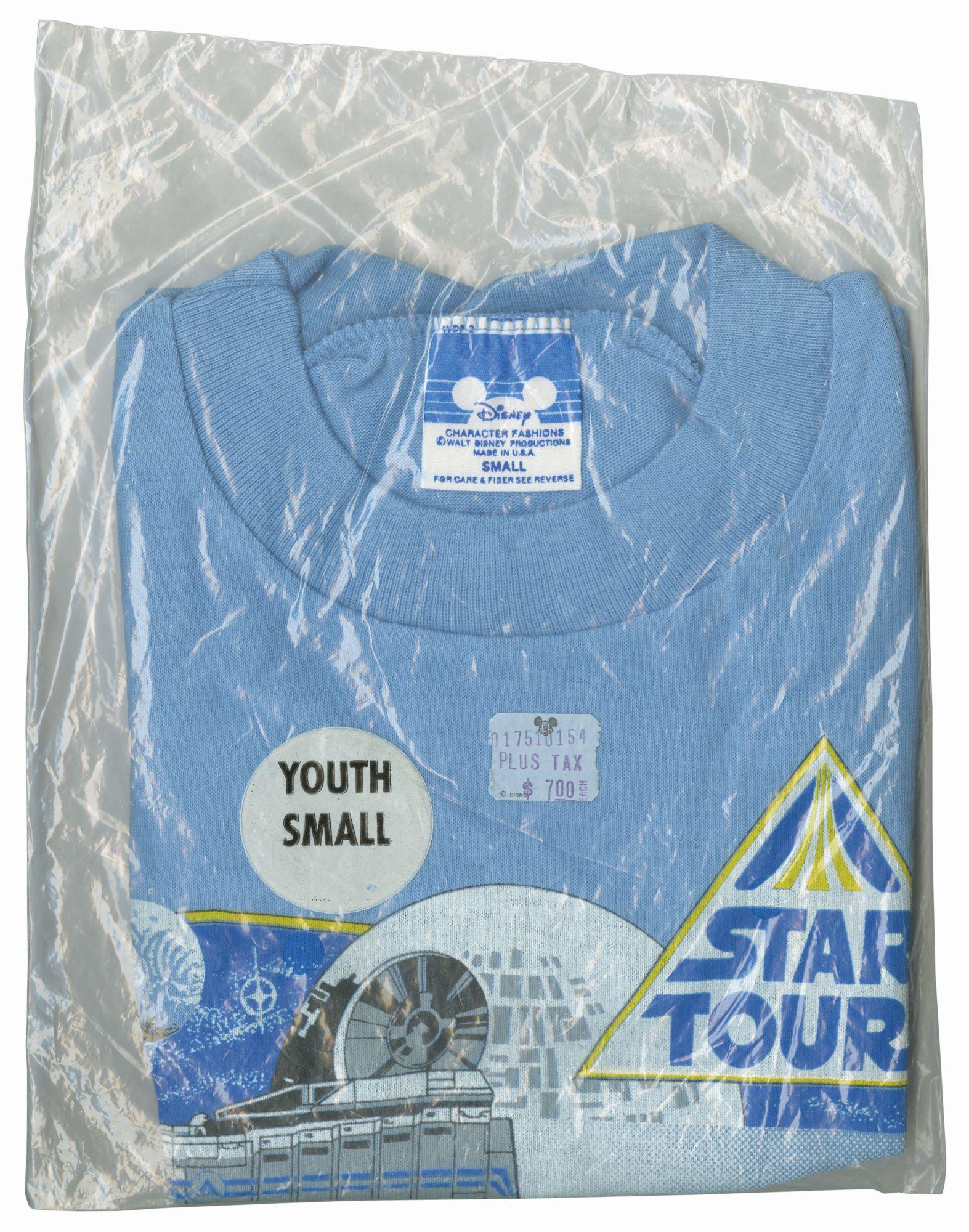 Star Tours Souvenir Shirt.: (Disneyland, 1986) A rare vintage Star Tours shirt in the original bag. The shirt features an image of the Death Star, C-3PO, and R2-D2. This shirt is a size youth small and is in very good condition,